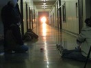 Photo of students on the floor to better observe the effects of the alignment of the sun with the end of the hallway.