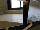 Photo of a grid drawn on plexiglass placed over a frame and a mirror placed above the grid.
