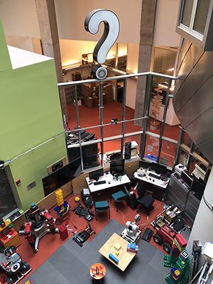Aerial view of room with robots and computers.