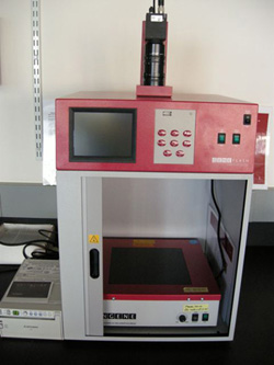 Photo of the gel documentation station, consisting of lower cabinet with a UV transilluminator, and upper unit with keypad.