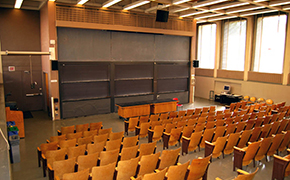 Image of tiered tables and chairs with an instructors table at the front of the room.