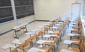 A classroom with several rows of student desks.