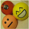 Photo of stress balls with different cartoon facial expressions on them.