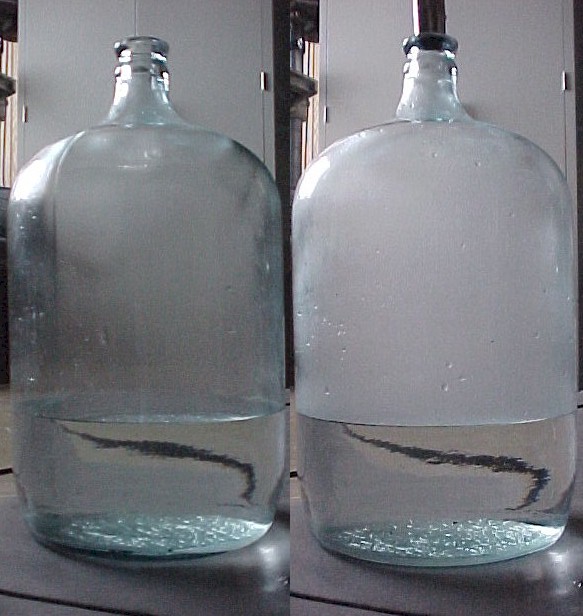 Clouds form in a large glass jar.