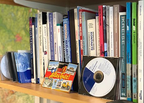 German textbooks and cds on book shelf.