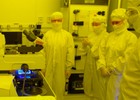 Students in goggles watch as UV light irradiates masked wafer.