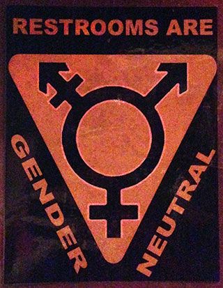 The words “Restrooms are gender neutral” surround a symbol featuring an “O” with an arrow and cross protruding from the top left, an arrow protruding from the top right, and a cross protruding from the bottom. 