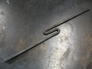 An S-shaped piece of metal, with the ends of the S being quite long, and the curves being quite tight, roughly the same width as the bar.