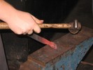It's easiest to work on the corners by bracing one edge against the anvil, leaving the other corner up.