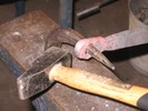 The hole in the workpiece is nearly an inch wide now, with the help of the hardy anvil.