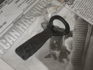 Polished bottle opener on a newspaper.