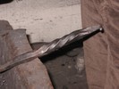 A square bar is hammered into an octagonal shape, twisted, and then hammered a bit more.