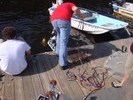 The multi-stranded tether coils up on the dock as a student hauls in the robot.