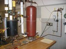 Lab 6 apparatus: black tank as reactor vessel, pipes with valves to simulate breaks in the reactor vessel, red tank as simulated containment vessel.