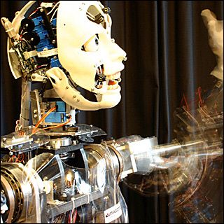 A humanoid robot moving waving its left arm.
