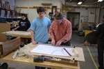 Reuben and a student begin to lay out a lines plan for the model to the right.