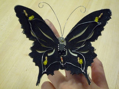 Photo showing top surface of the PCButterfly, with LEDs, integrated circuit device, ground wire and phototransistor.