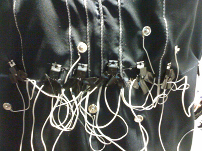 Photo close-up of the dress wiring around the waist, with many wires, connectors and snaps.