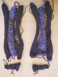 Photo of the completed knitting for each part, arranged in roughly slipper-form.