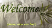 Close up photo of embroidered fabric with the word ‘Welcome.’.