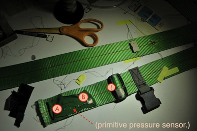 Photo showing the pressure sensor on the end of the belt, with points A, B, and !.