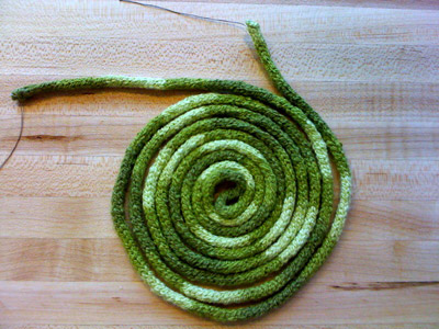 Photo of a coiled length of knitted yarn.