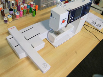 Photo of sewing machine with embroidery arm attachment.