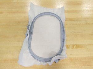 Two photos showing the process of putting fabric and interfacing into a two-part embroidery hoop.