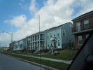 Newly built homes stand in a row along a street.
