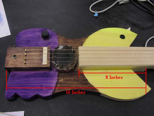 Guitar body with neck measurements shown.