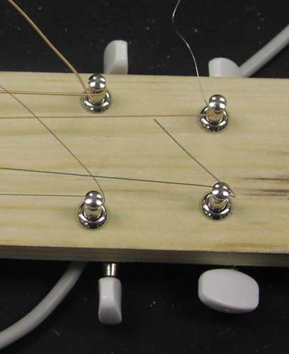 Close-up of guitar tuning knobs.