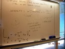 Notes on a whilteboard explain relationship between temperature, lumnosity, and radius of star.