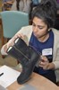A woman is adding electronic components to a boot.