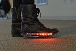 Boots with a strip of red lit up LEDs.